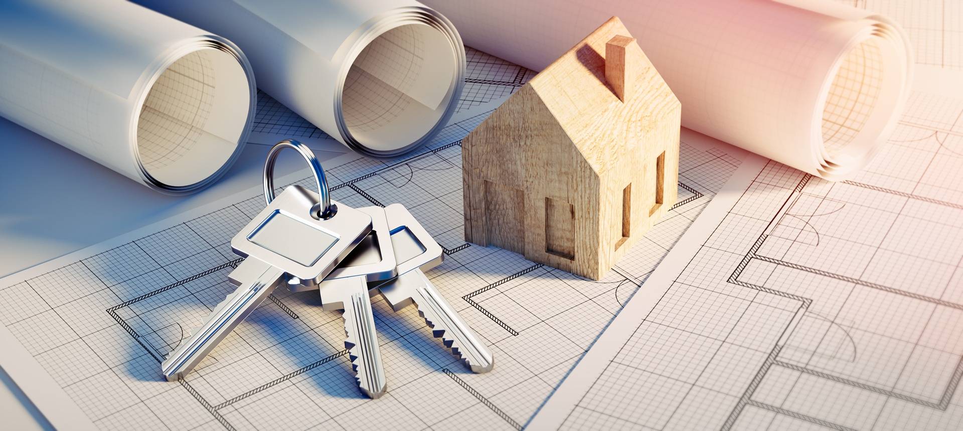 Hausmodell und Schluessel auf Bauplänen | Baufinanzierung Aachen