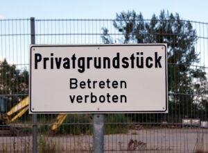 Schild mit Aufschrift Privatgrundstück Betreten verboten | Parkplatzsperre